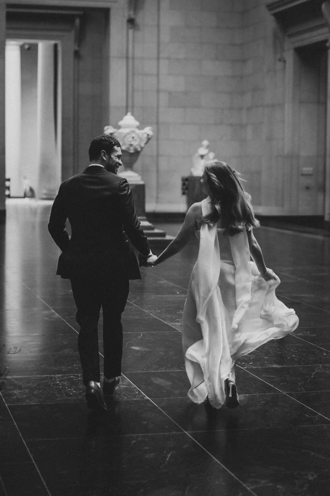 Running hand in hand through the gallery, in black and white