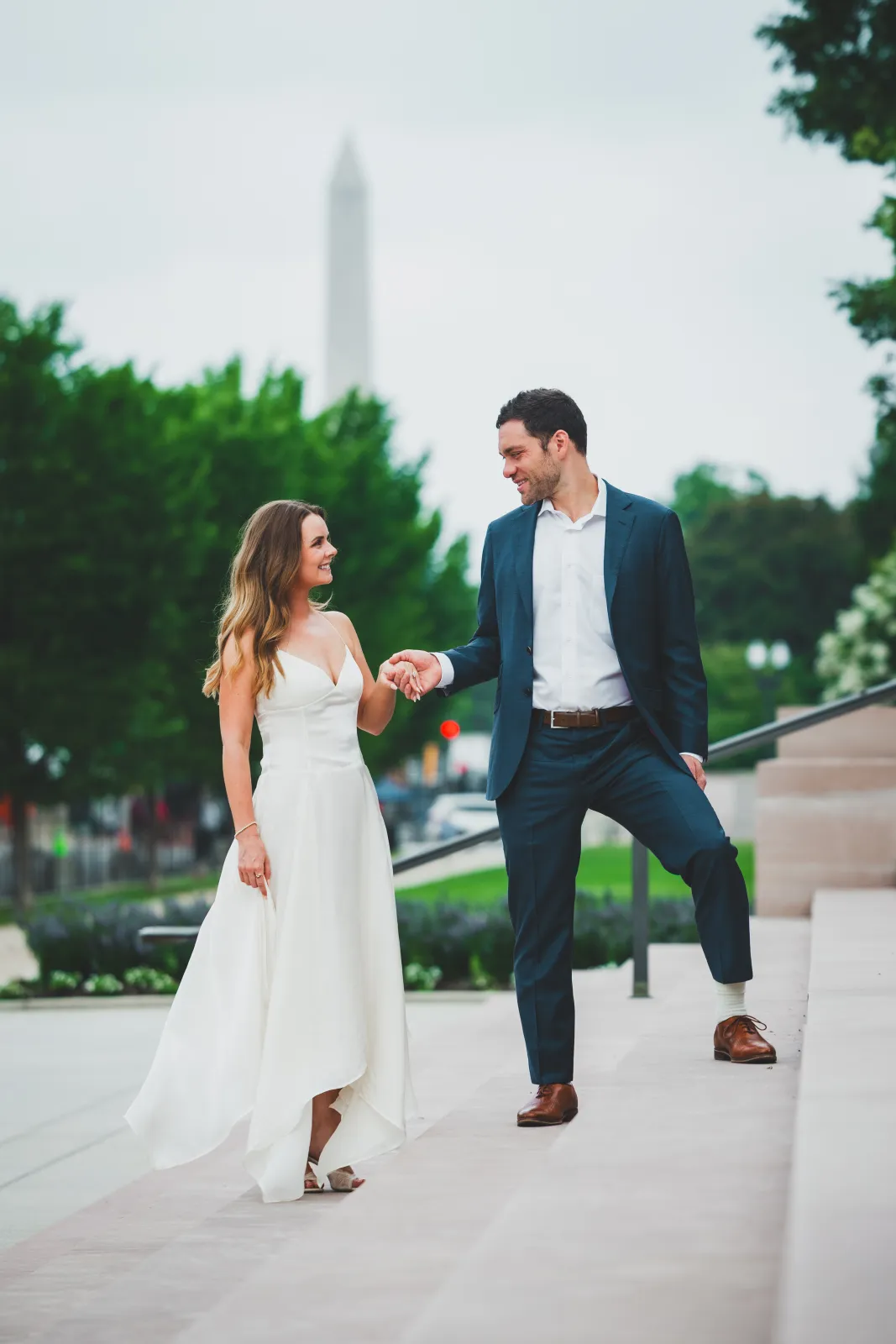 On the steps, the Washington Monument rising behind